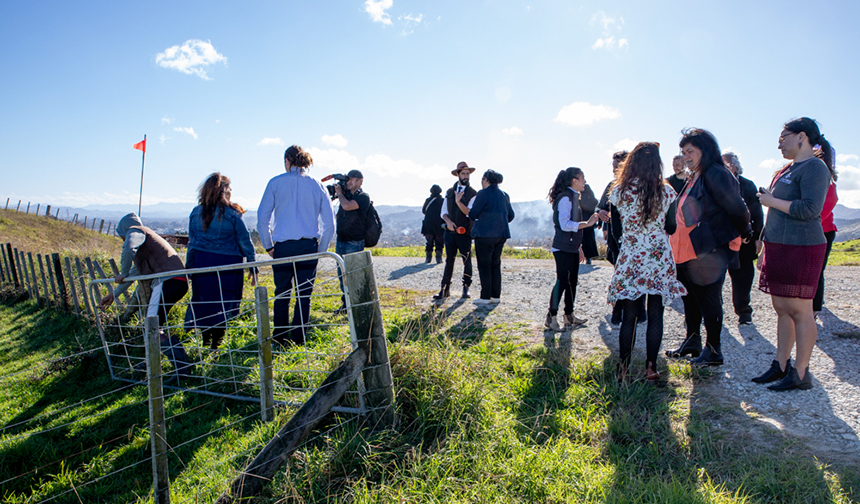 People gathered together on a gravel track.